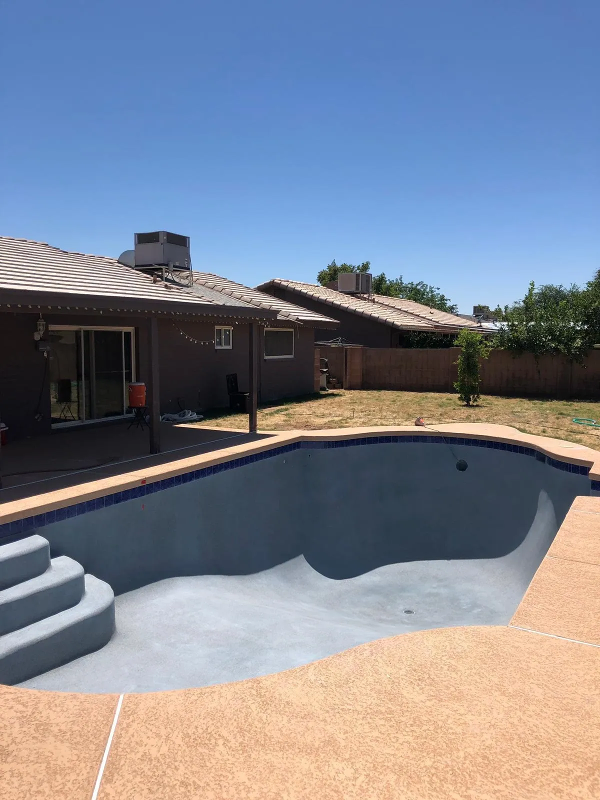 Existing pool shell after interior and tile installation, not yet filled