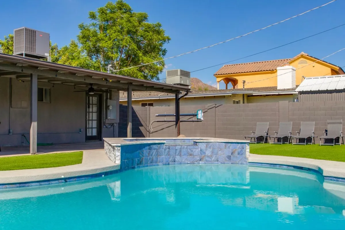 Filled pool and raised spa viewed from the covered patio