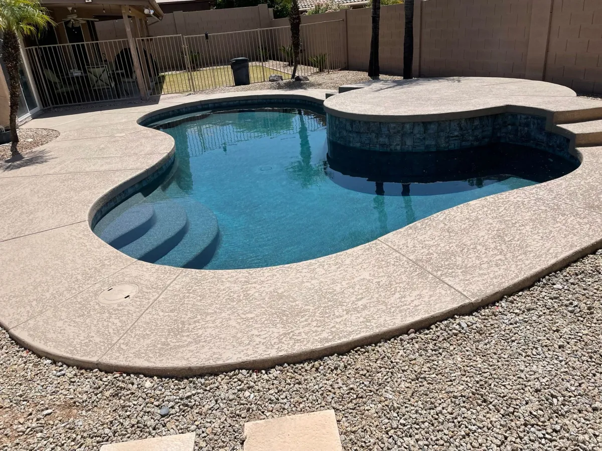 Completed pool and raised spa with renewed dark interior and waterline