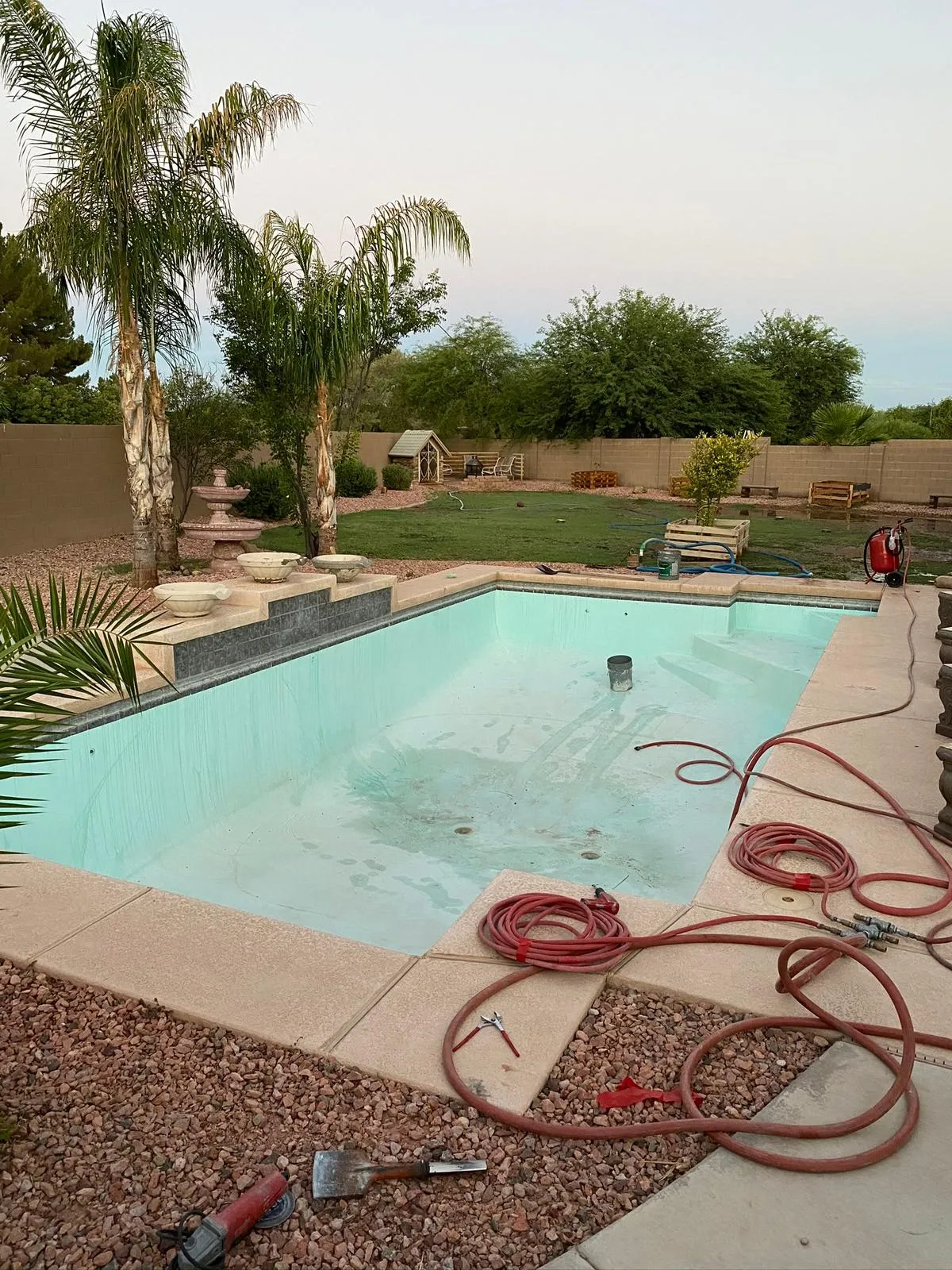 Pool before resurfacing, freshly replastered and filling with water