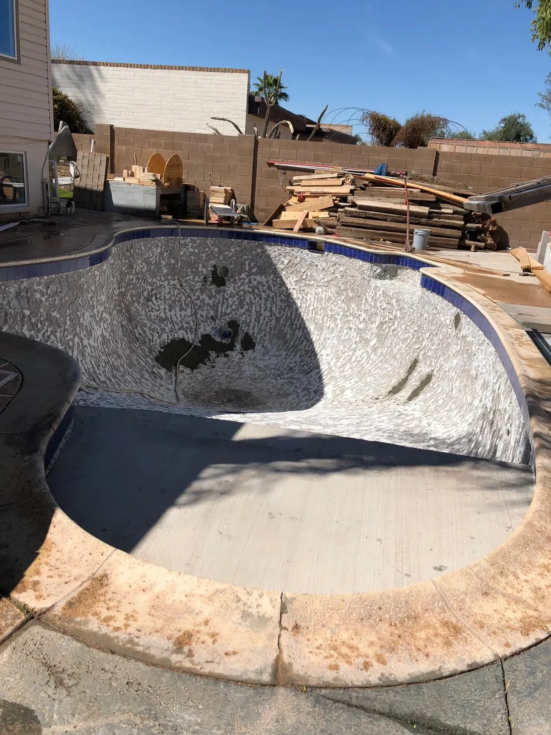 Existing pool shell during interior surface preparation