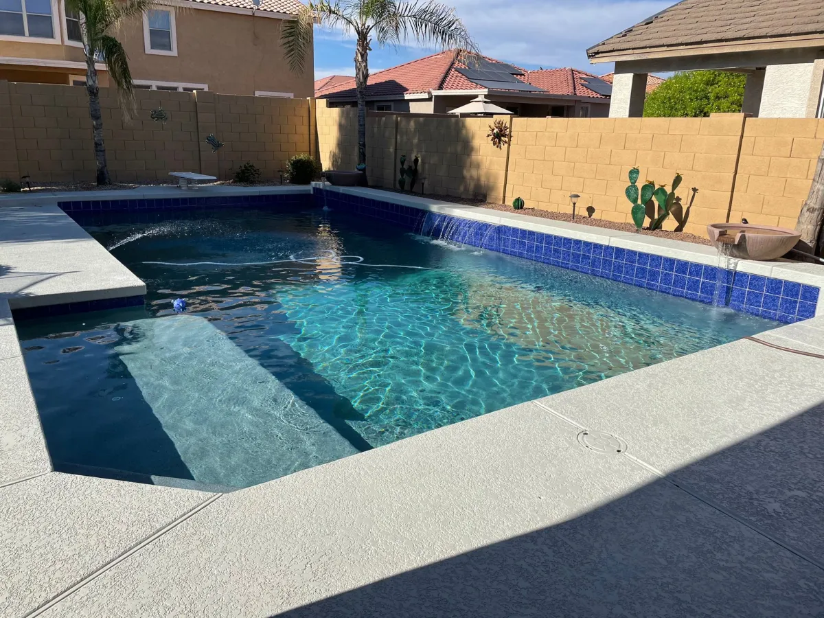 Compact existing pool with a renewed deep blue textured interior
